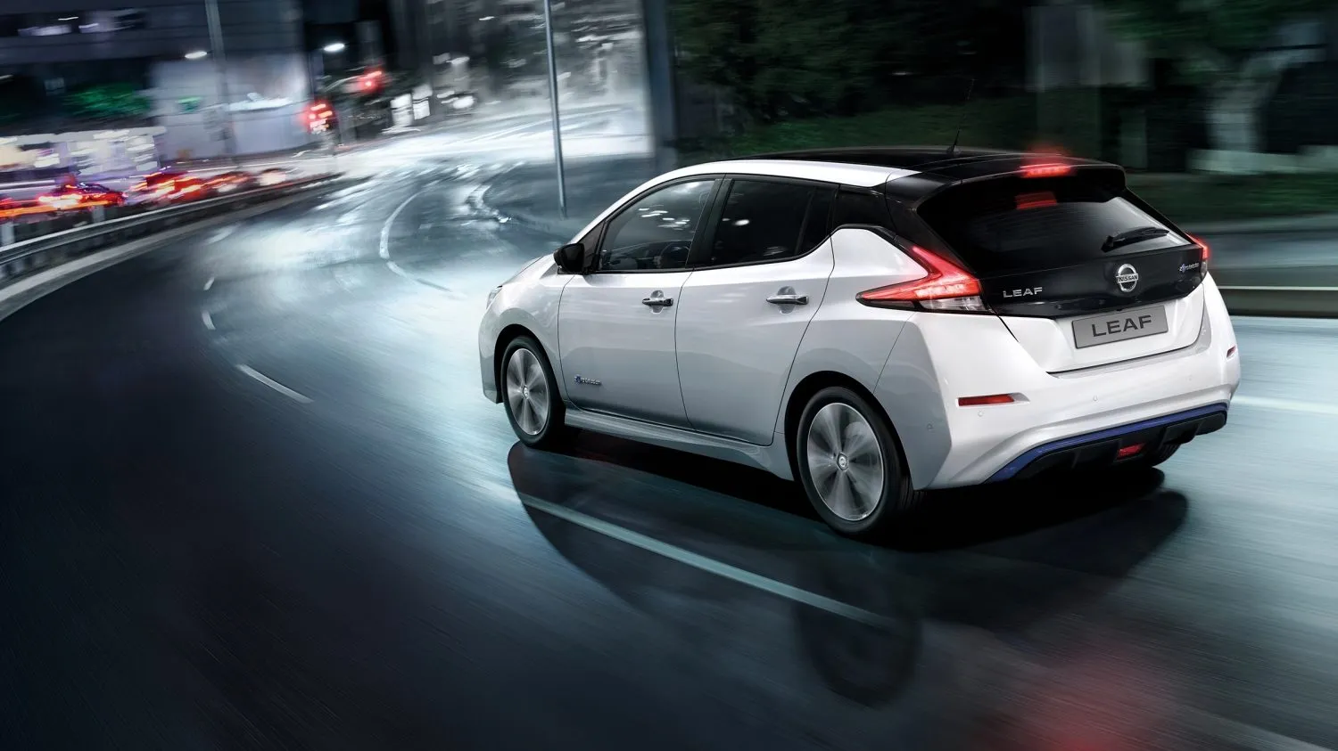White Nissan Leaf Range on a dark highway