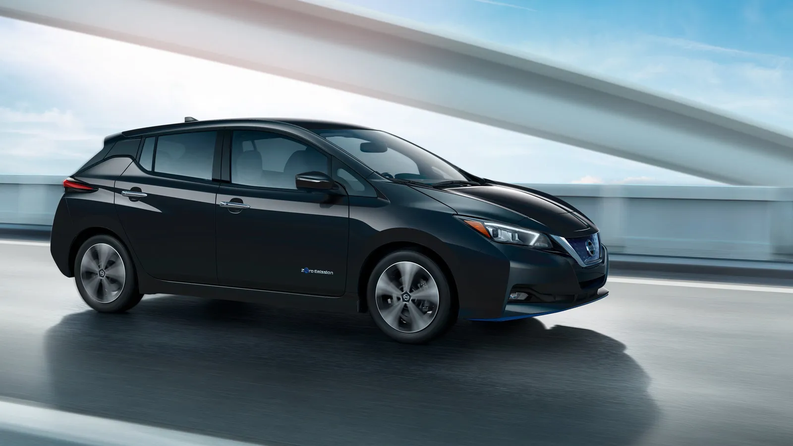 Black Nissan Leaf Range running on a highway